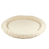 Rond lichtbeige katoenen speelnest met een opstaande, gewatteerde rand op een witte achtergrond.